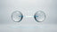 Two translucent glass spheres joined by a luminous blue bond, an abstract rendering of a molecular hydrogen pair, on a clean white background